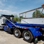 photo of a new blue roll off container truck body